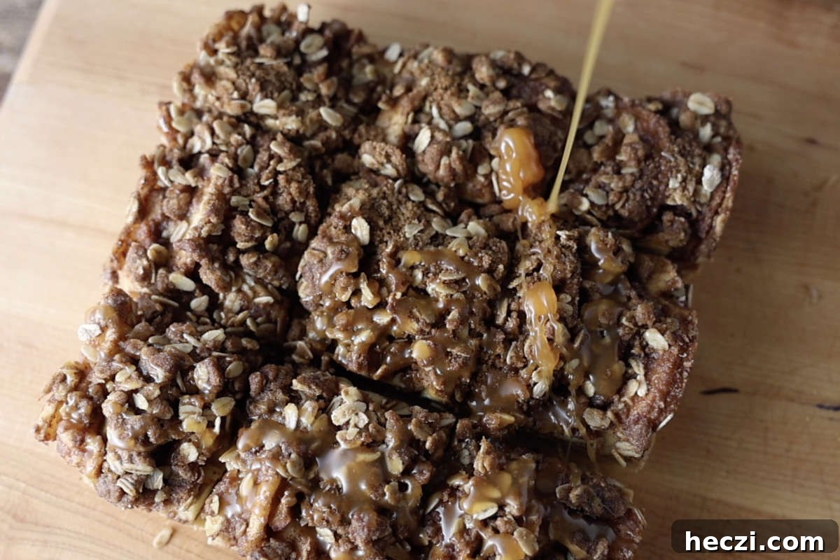 Chewy Apple Crisp Bars with Cinnamon Streusel 11 Drizzling caramel sauce over apple crisp bars.