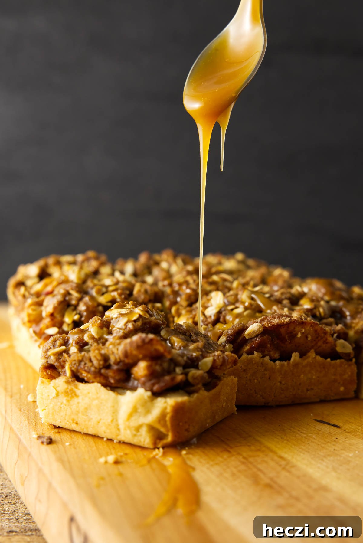Chewy Apple Crisp Bars with Cinnamon Streusel 13 Drizzle of a salted caramel sauce over square slices of apple crisp bars.