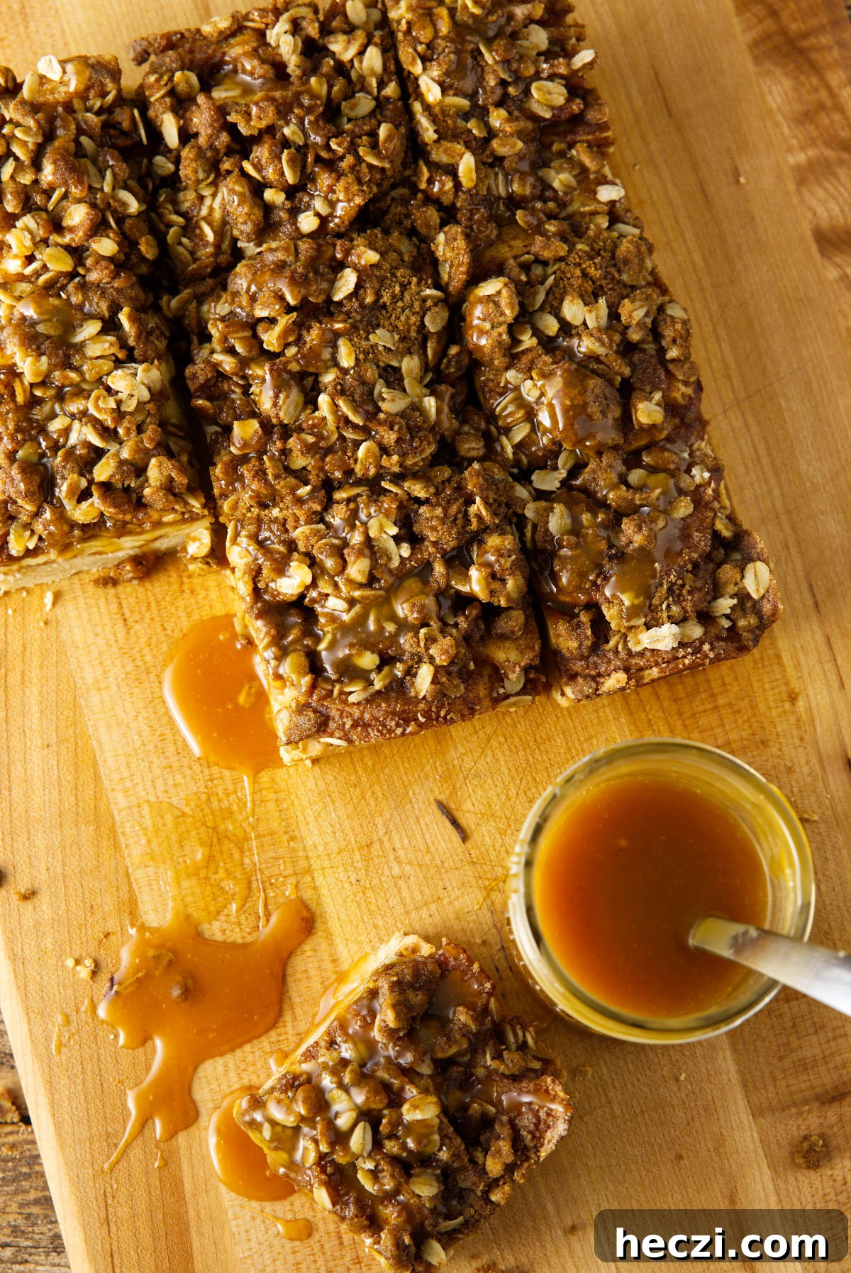 Chewy Apple Crisp Bars with Cinnamon Streusel 3 Apple crisp bars with oat streusel on top and a salted caramel sauce in a mason jar.