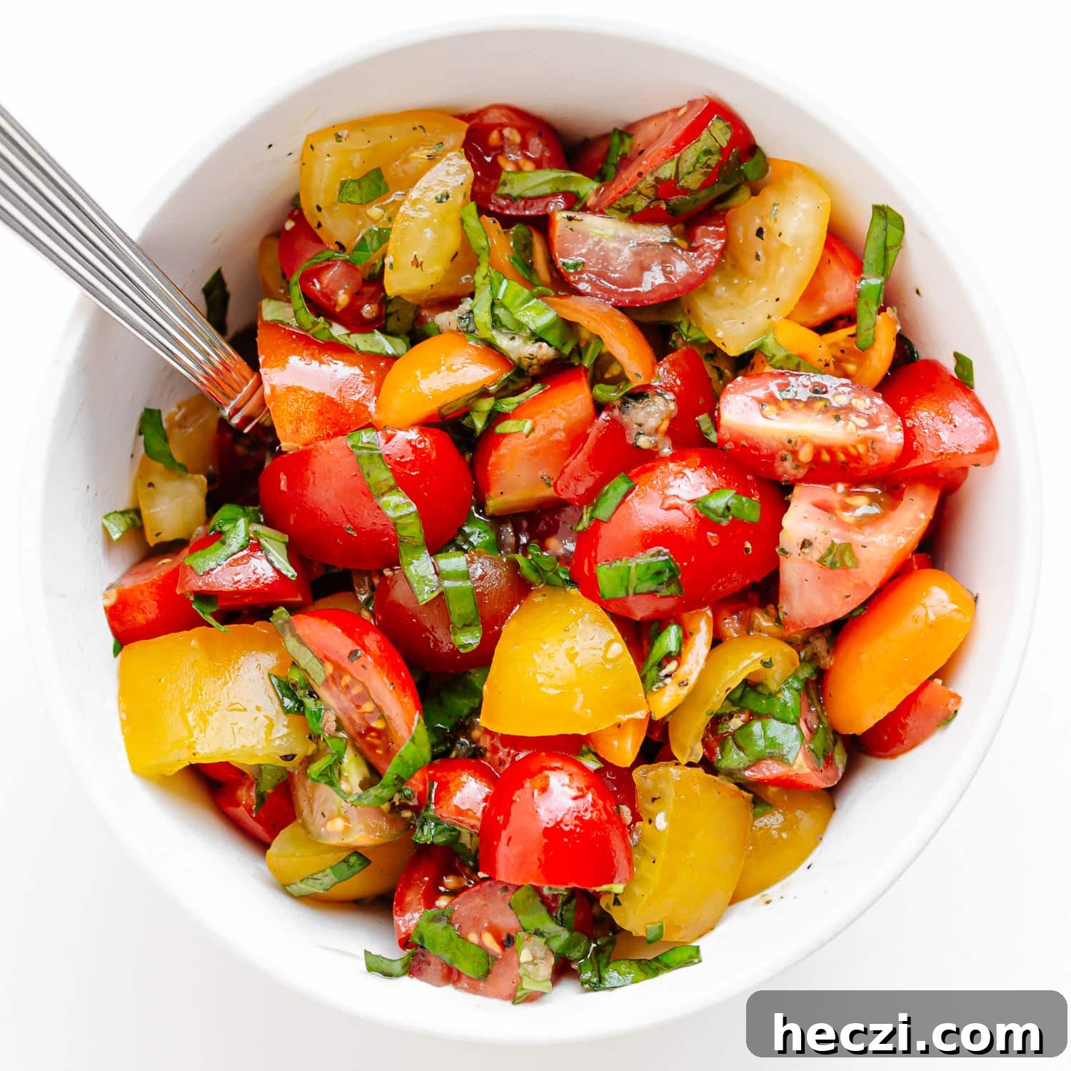 Marinated tomato basil topping in white bowl.