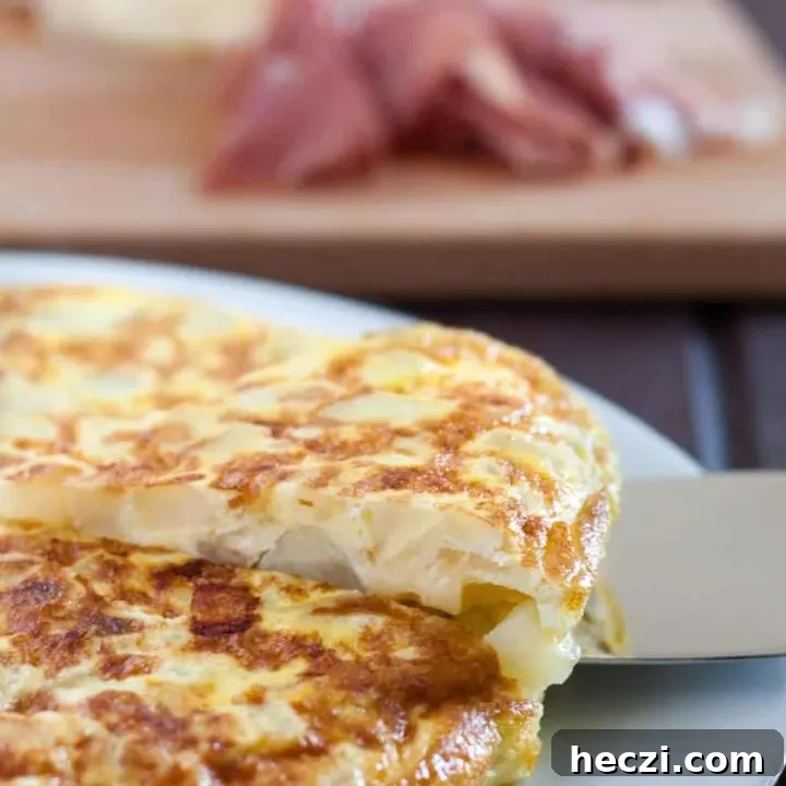 Tortilla Espanola - Spanish Tortilla - is a classic egg and potato dish with infinite variations served all over Spain and in some parts of the Caribbean. An easy budget meal, tortilla can be served any time of day, or cut into cubes and served as a party appetizer! Recipe and variations on GoodieGodmother.com
