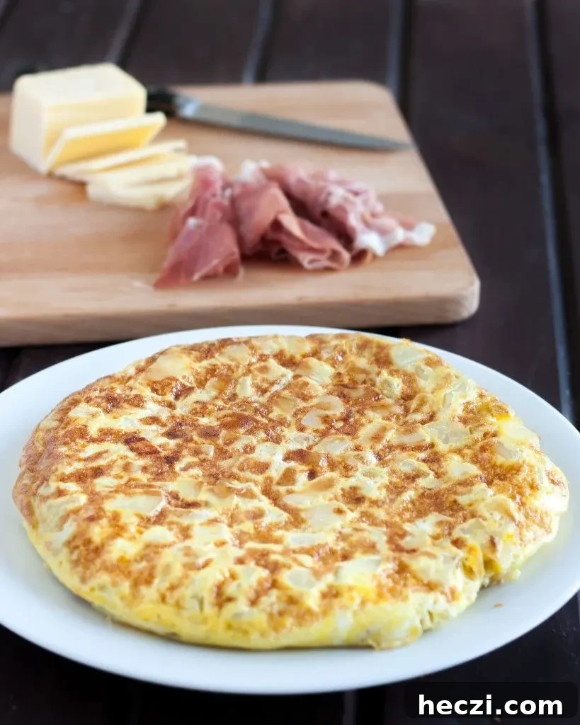 Spanish Omelette Recipe: Classic Tortilla Española Guide 3 Tortilla Espanola - Spanish Tortilla - is a classic egg and potato dish with infinite variations served all over Spain and in some parts of the Caribbean. An easy budget meal, tortilla can be served any time of day, or cut into cubes and served as a party appetizer! Recipe and variations on GoodieGodmother.com