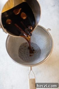 Homemade Gingerbread Syrup Recipe for Coffee & Cocktails 10 straining gingerbread syrup