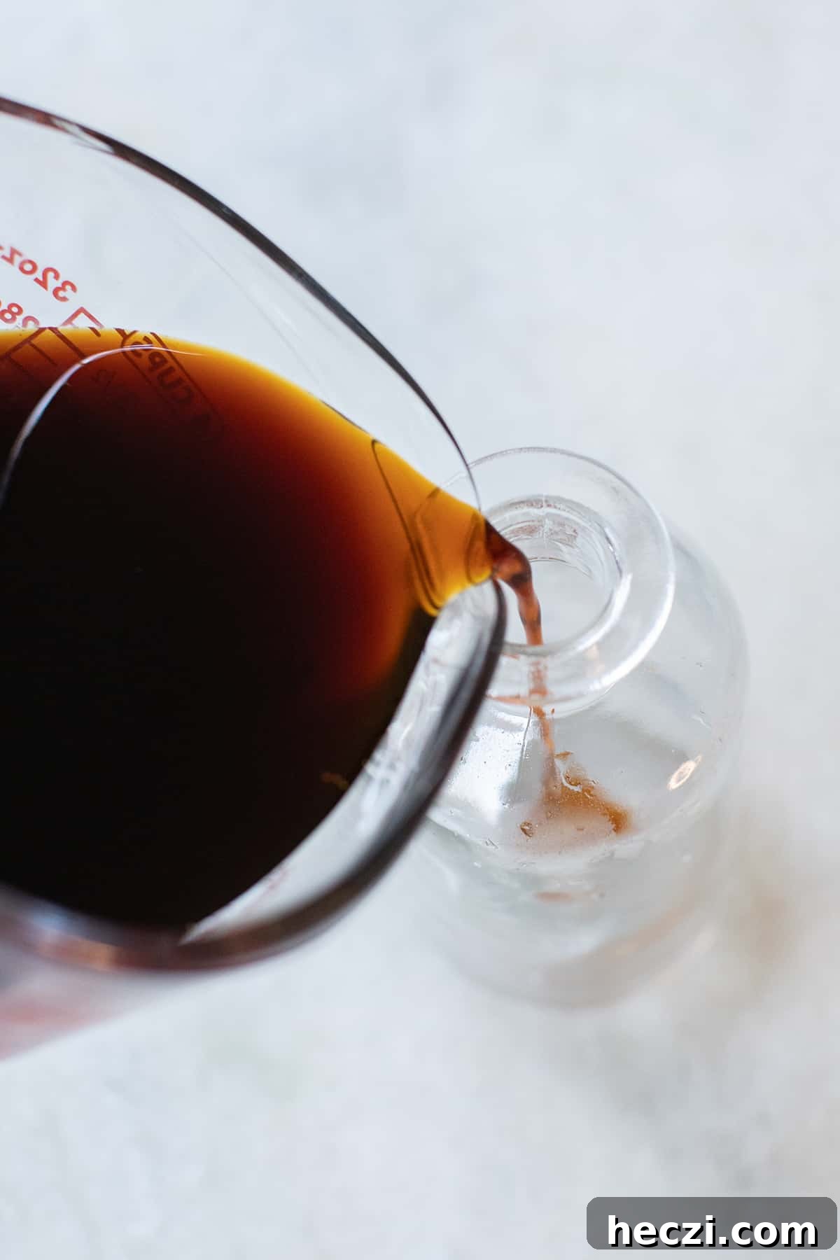 Homemade Gingerbread Syrup Recipe for Coffee & Cocktails 6 pouring syrup into glass jars