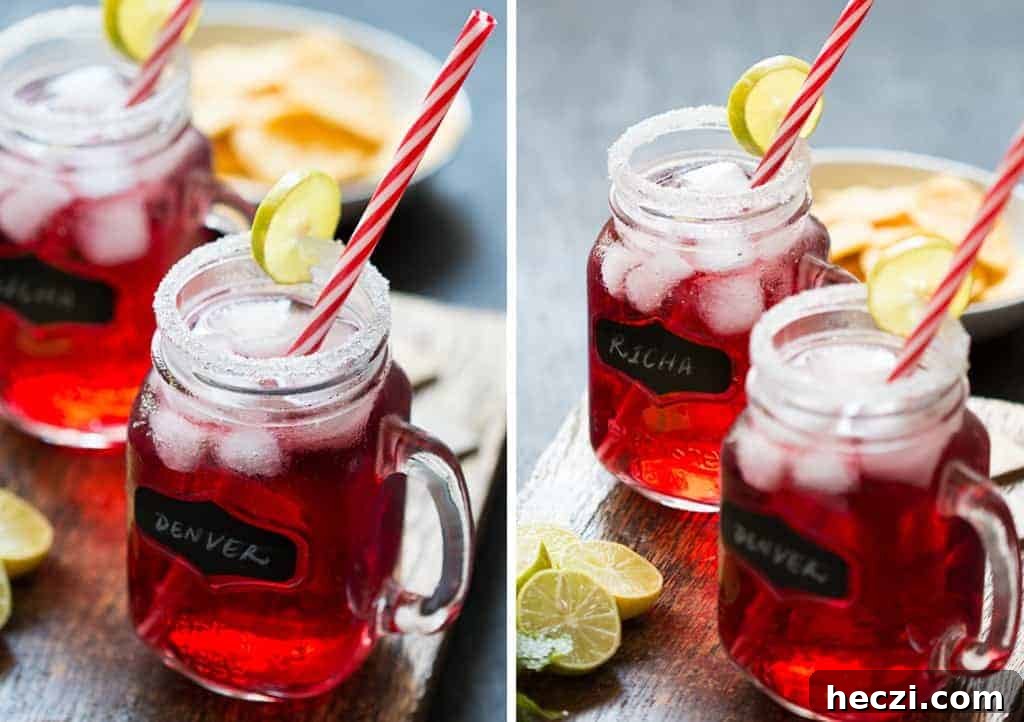 Cranberry Ginger Holiday Cocktail served in mason jars with sugar coated rims and a slice of lime.