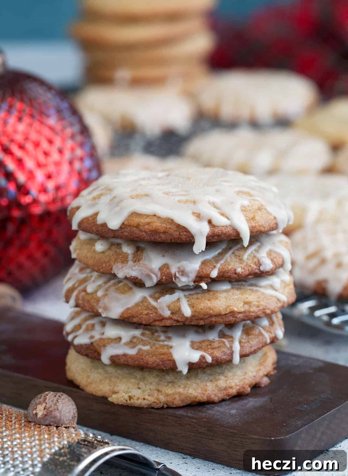 Chai-Spiced Eggnog Cookies Recipe for the Holidays 7 Eggnog cookies stacked on a small serving board with an ornament in the background.