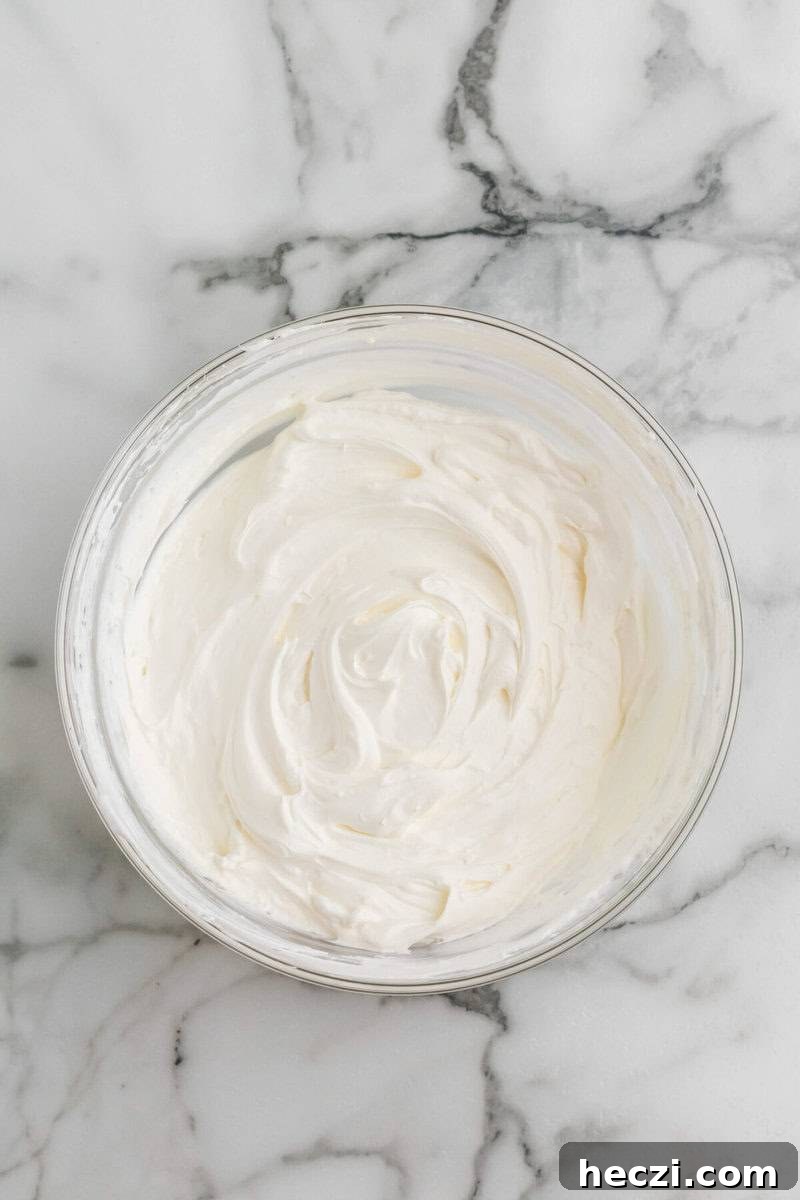bowl of the cream cheese mixed with the whipped topping.