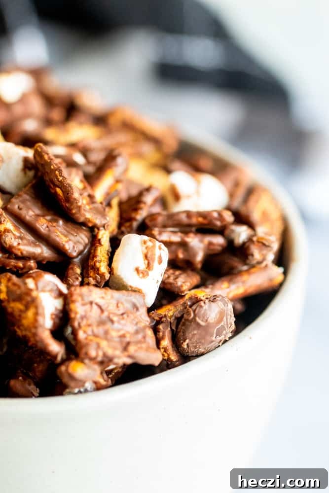 Close up shot of s'mores mix in white bowl on white counter.