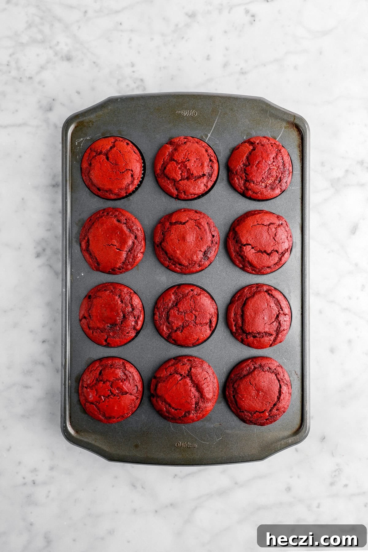 Red Velvet Molten Lava Cupcakes: Gooey Chocolate Center Delight 9 baked red velvet cupcakes in muffin pan.