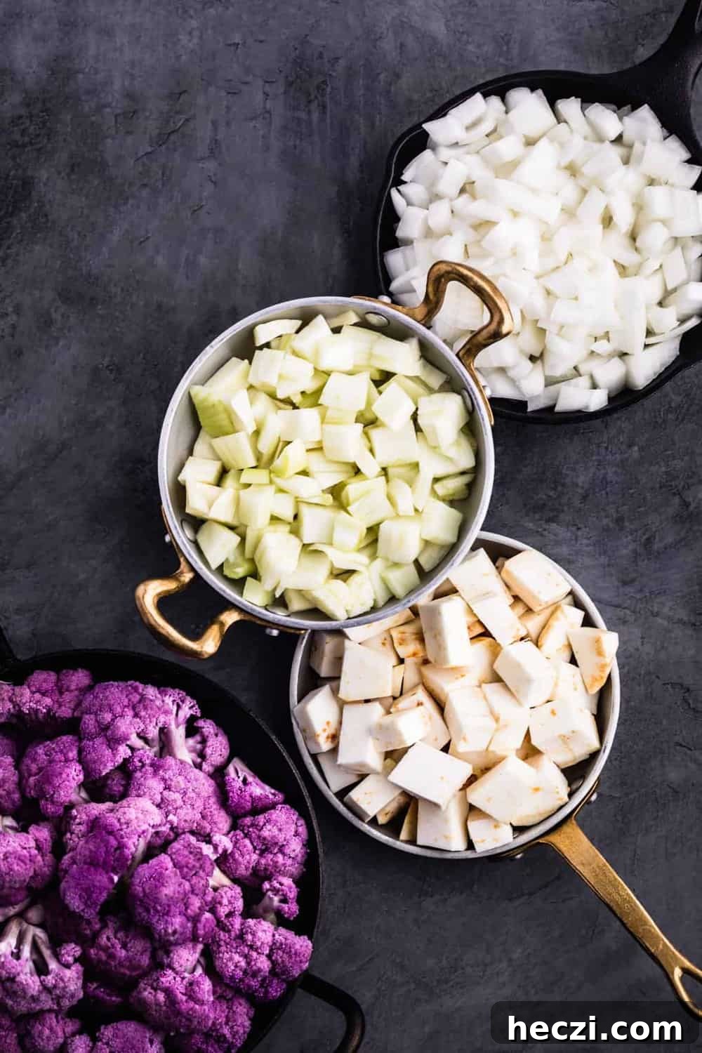 Ingredient prep shot with the cut up cauliflower, onions, celery root and fennel.
