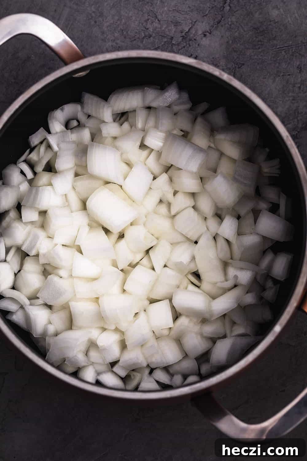Raw onions on the pot about to be sautéed with olive oil.
