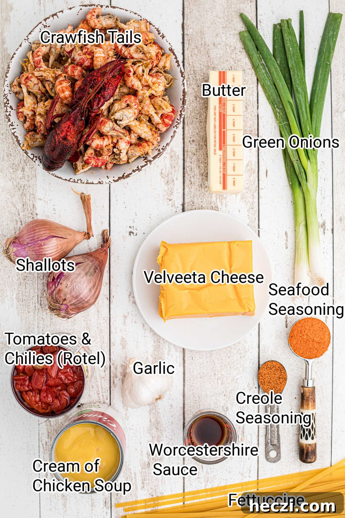 Creamy Crawfish Fettuccine with Garlic and Parmesan 3 ingredients needed for a crawfish fettuccine all arranged nicely and laid out with names typed