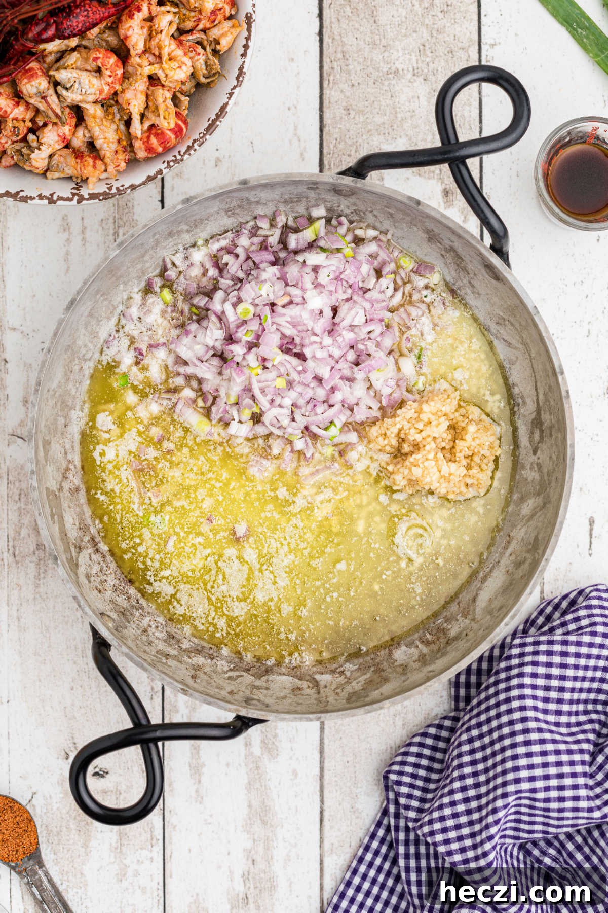 Creamy Crawfish Fettuccine with Garlic and Parmesan 7 A skillet with melted butter and onions.