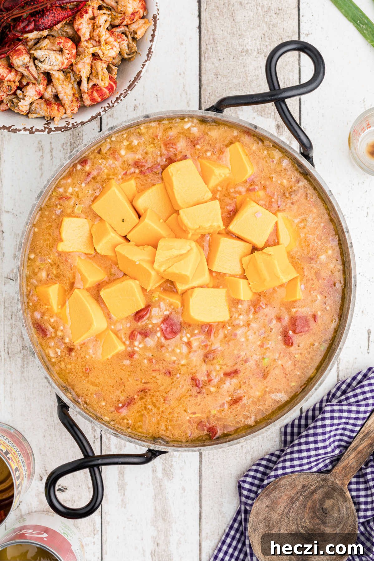 Creamy Crawfish Fettuccine with Garlic and Parmesan 9 Cubes of velveeta added to a skillet making a cheese sauce.