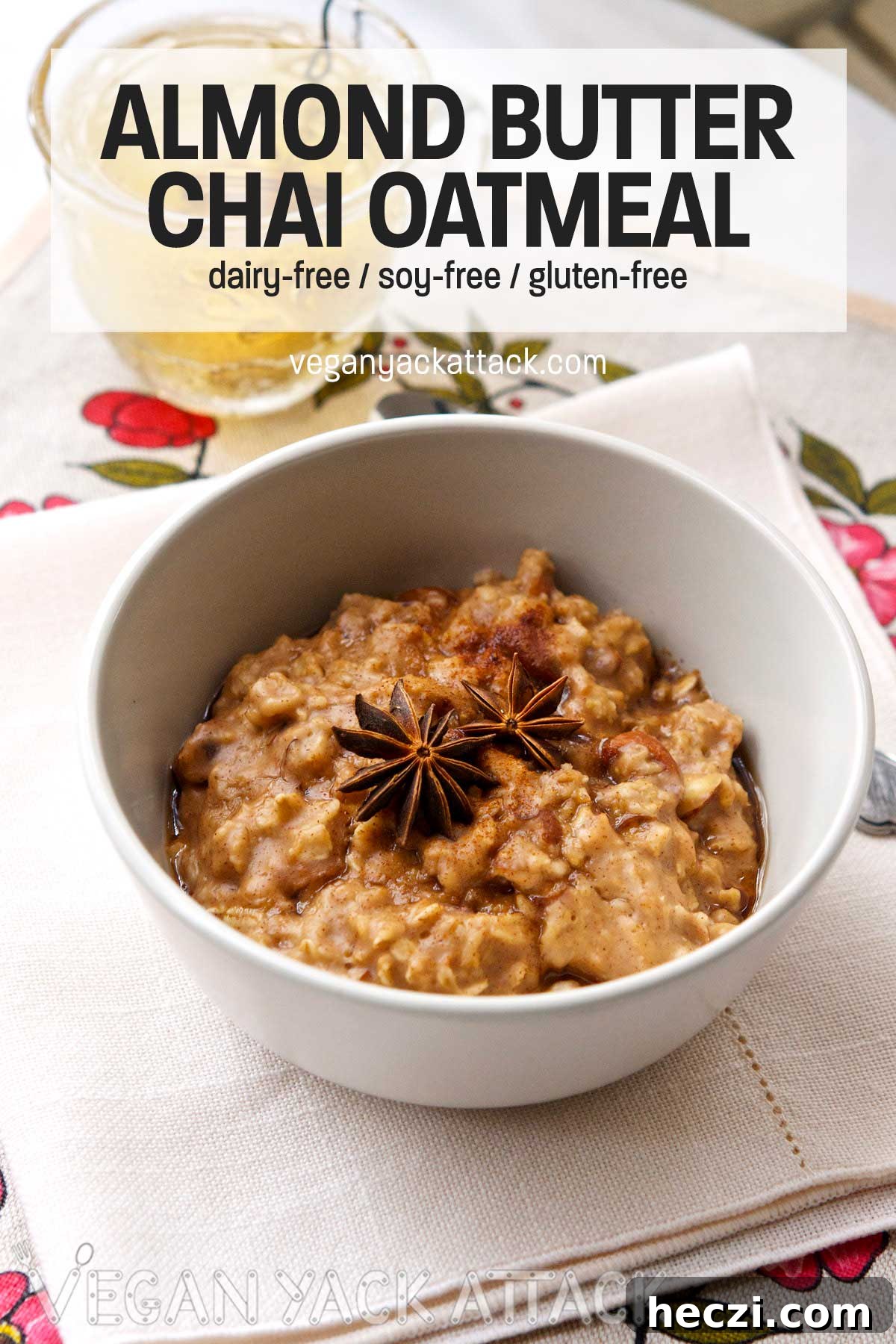 For a healthy, comforting breakfast that comes together in minutes, make this Almond Chai Oatmeal! light grey bowl of oatmeal topped with star anise, text overlay saying 'almond butter chai oatmeal'