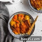 Japanese Chicken Katsu Curry Recipe — Crispy Cutlet with Rich Curry 16 Chicken Katsu Curry in a blue Japanese porcelain bowl with blue and wood bamboo chopsticks and a white Le Creuset dutch oven