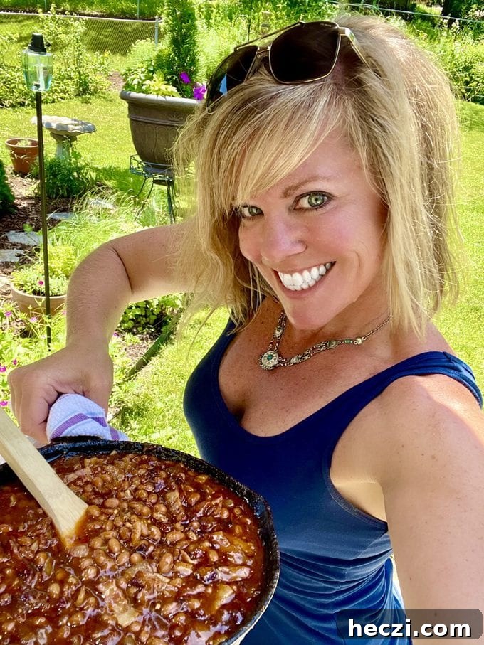 Jennifer holding a skillet of baked beans