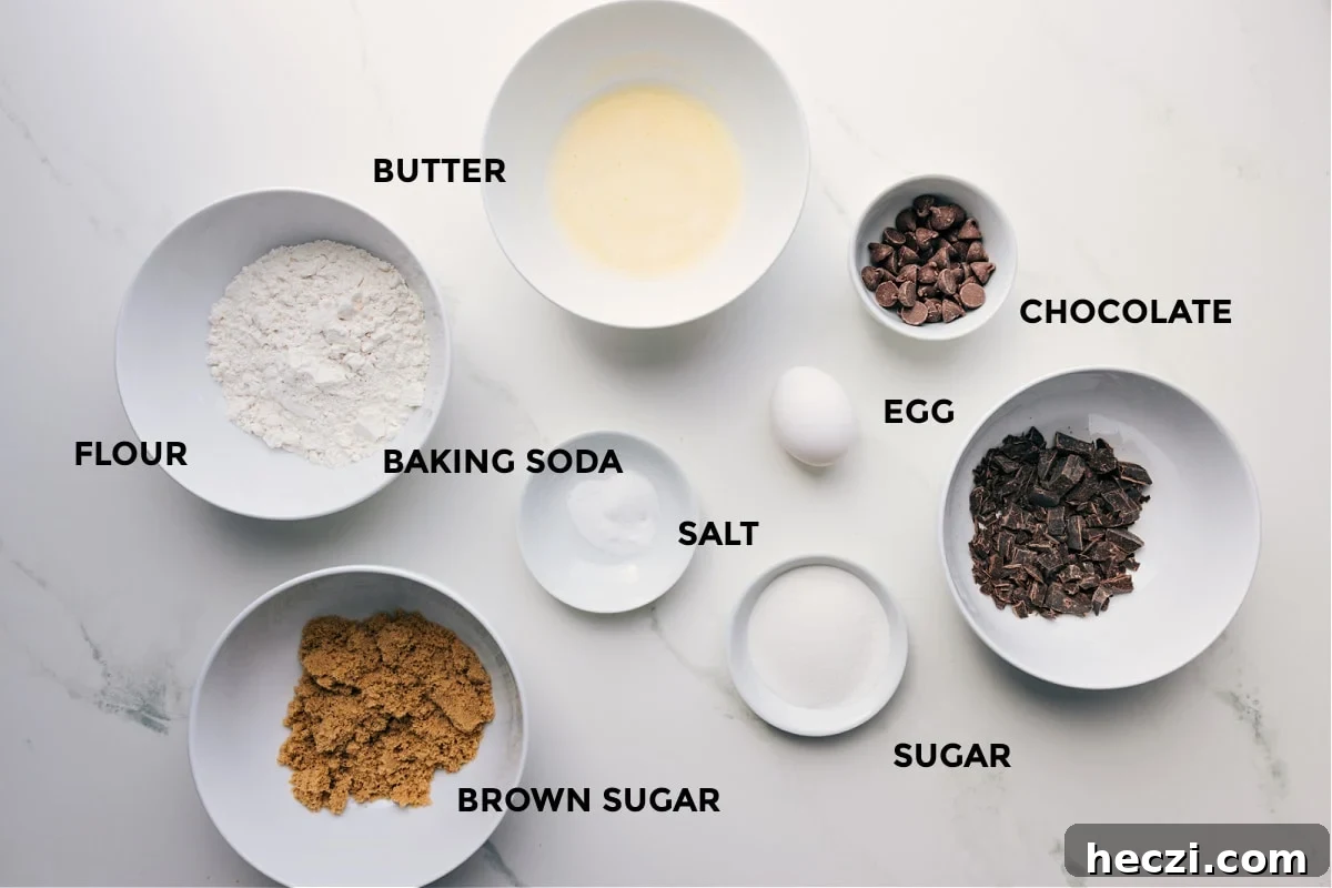 Ingredients prepped for easy assembly, including butter, flour, baking soda, chocolate, egg, sugar, and brown sugar.