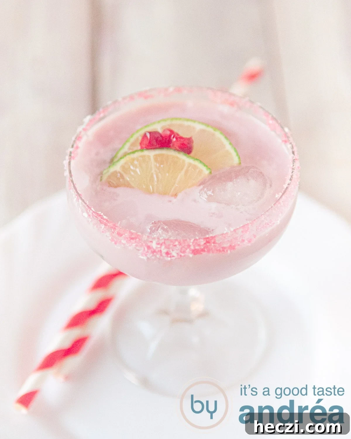 Fresh pomegranate cocktail with garnish of lime and pomegranate
