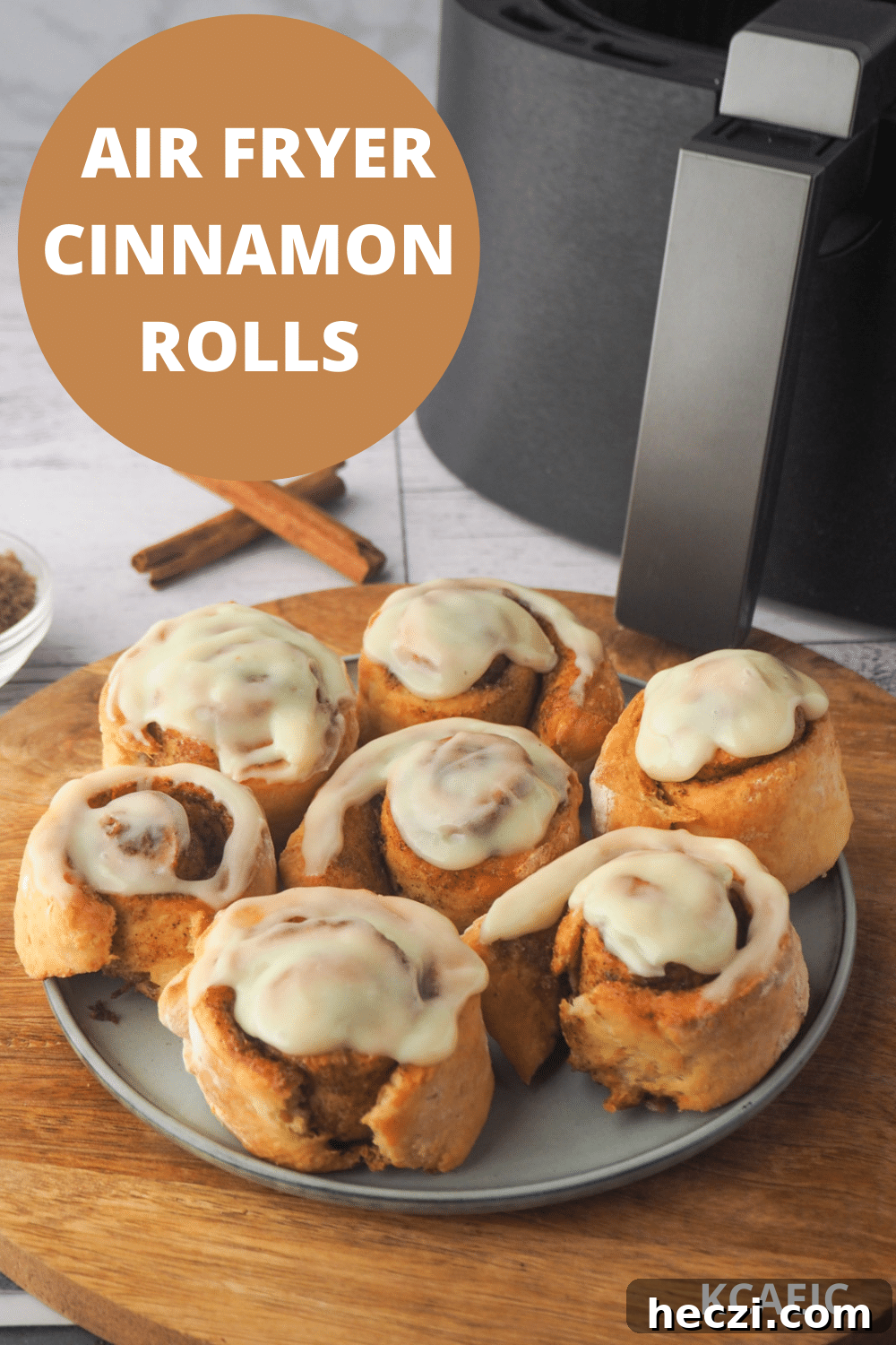 Air Fryer Cinnamon Rolls: Quick, Fluffy Homemade Recipe 20 Scrolls on a plate, with air fryer in the background and text overlay, air fryer cinnamon scrolls and KCAEIC.