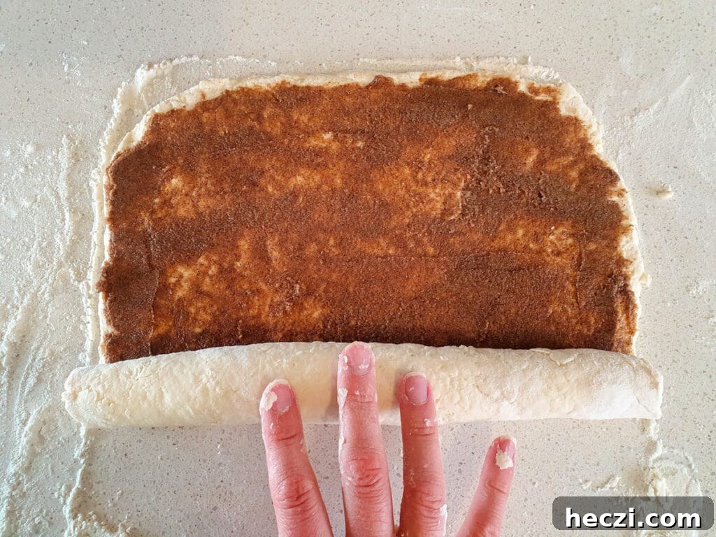 Air Fryer Cinnamon Rolls: Quick, Fluffy Homemade Recipe 10 Rolling up dough.