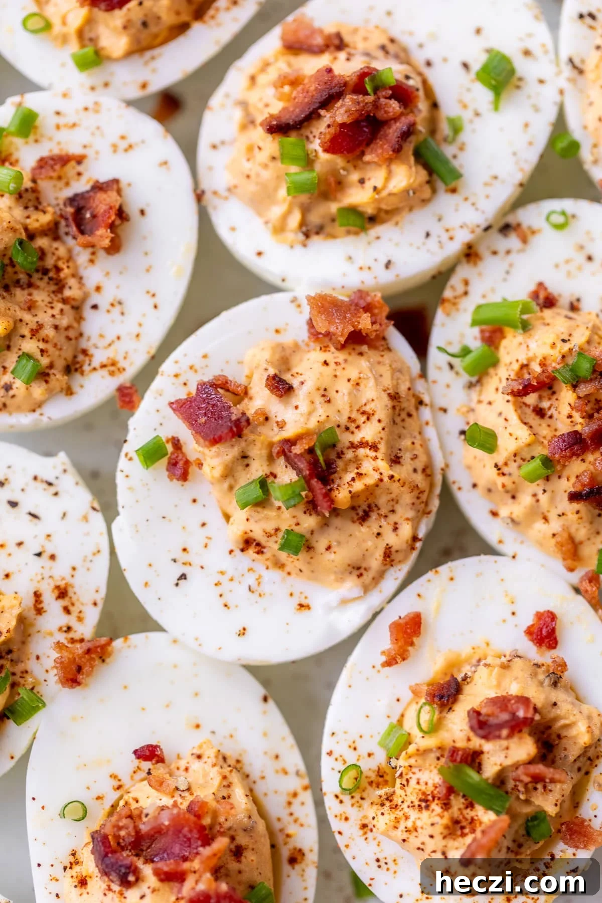 chipotle deviled eggs topped with chives