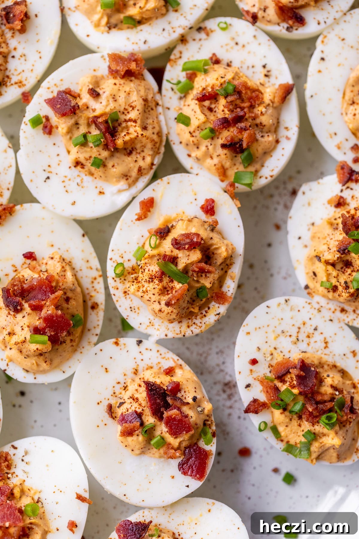 chipotle deviled eggs topped with chives