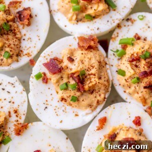chipotle deviled eggs topped with chives