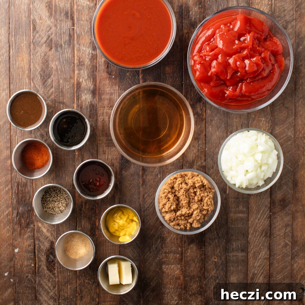 Sweet and Spicy BBQ Sauce Recipe for Grilling and Dips 3 sweet & spicy bbq sauce ingredients. bowls of ketchup, diced onion, apple cider vinegar, brown sugar, tomato sauce, pinch bowls with molasses, honey, mustard, unsalted butter, granulated garlic, black pepper, Worcestershire sauce, and chipotle chili powder