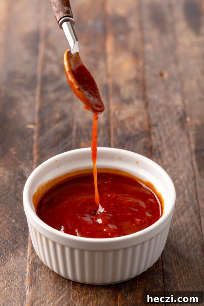 Sweet and Spicy BBQ Sauce Recipe for Grilling and Dips 4 bowl of sweet & spicy bbq sauce with a spoon dripping sauce