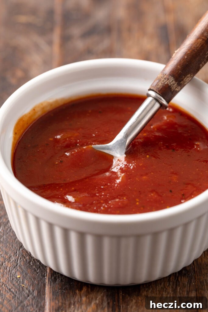 Sweet and Spicy BBQ Sauce Recipe for Grilling and Dips 5 bowl of sweet & spicy bbq sauce in a bowl with a spoon