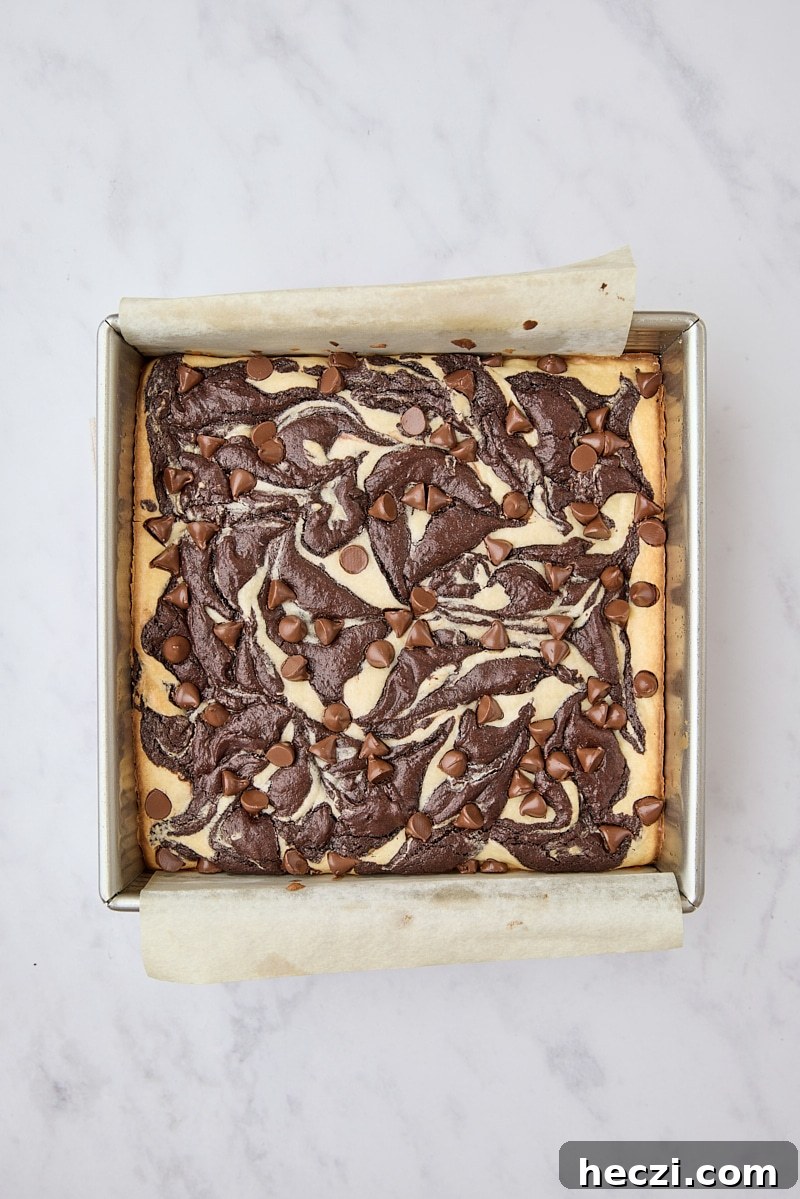 Fudgy Brownies with Cream Cheese Swirl Recipe 11 Baked cream cheese brownies in parchment-lined pan