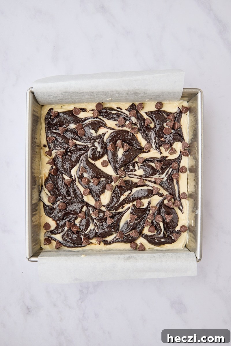 Fudgy Brownies with Cream Cheese Swirl Recipe 10 Assembled cream cheese brownies in parchment-lined pan