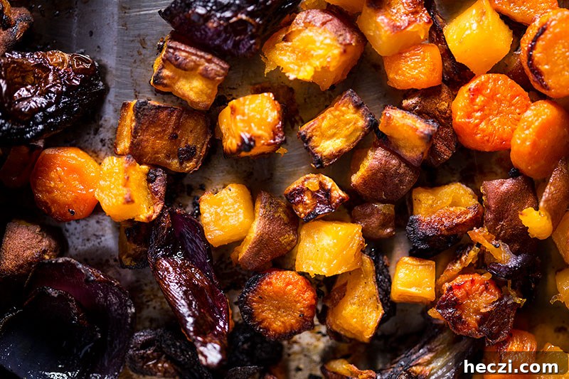 Charred roasted root vegetables in a baking tray
