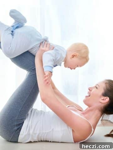 Mom on the floor on her back with her toddler on her knees.