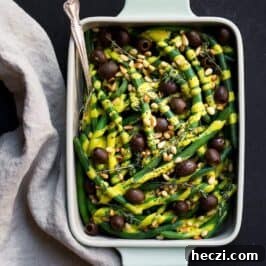 A perfect side dish for your Thanksgiving table or any time of year: green beans with dairy-free pumpkin alfredo and olives. Paleo Thanksgiving recipe.