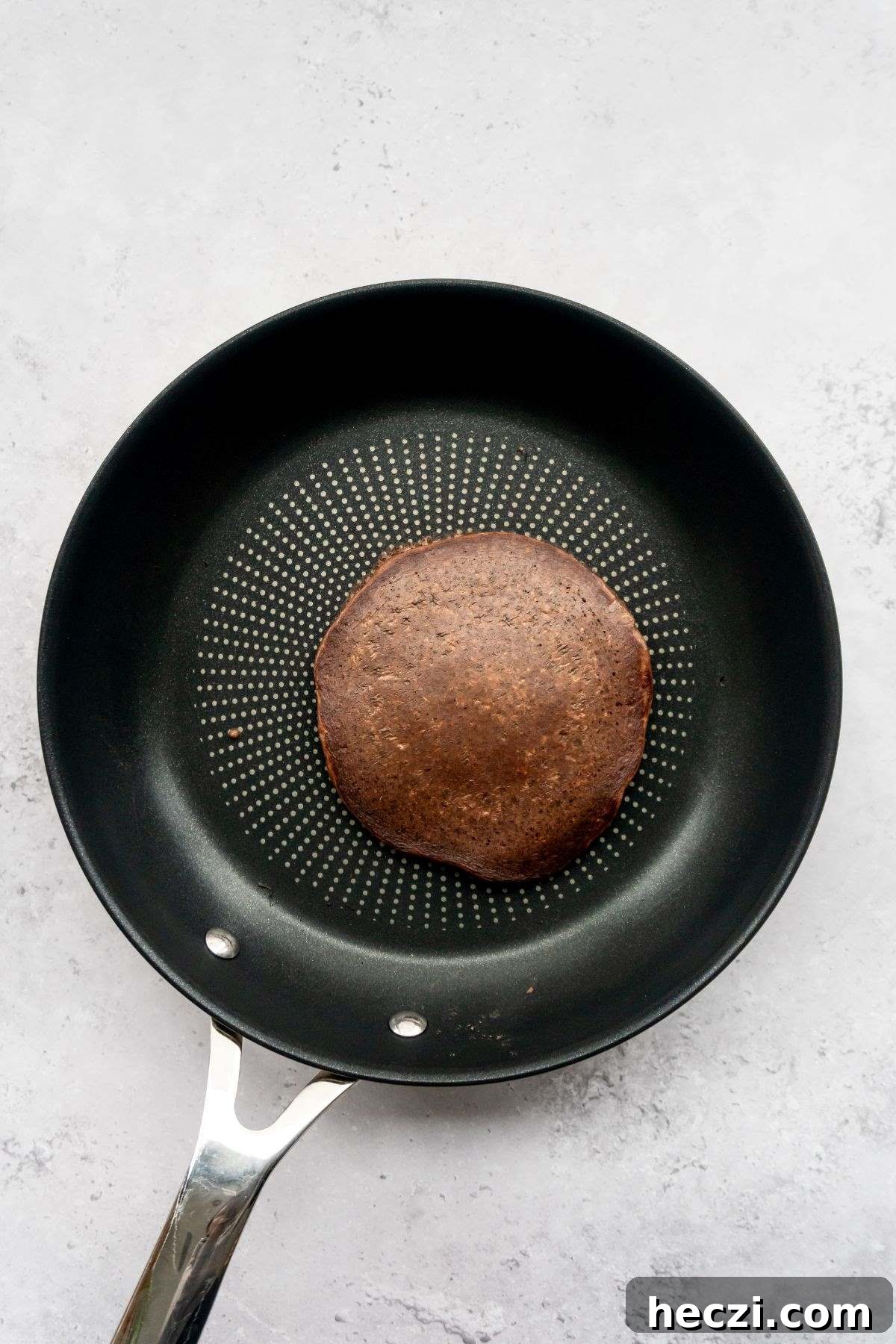 Chocolate pancake in a frying pan.