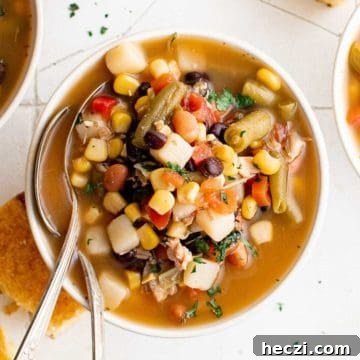 Top down view of a bowl of chicken and vegetable soup.