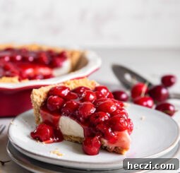 slice of cherry cream cheese pie on a plate.