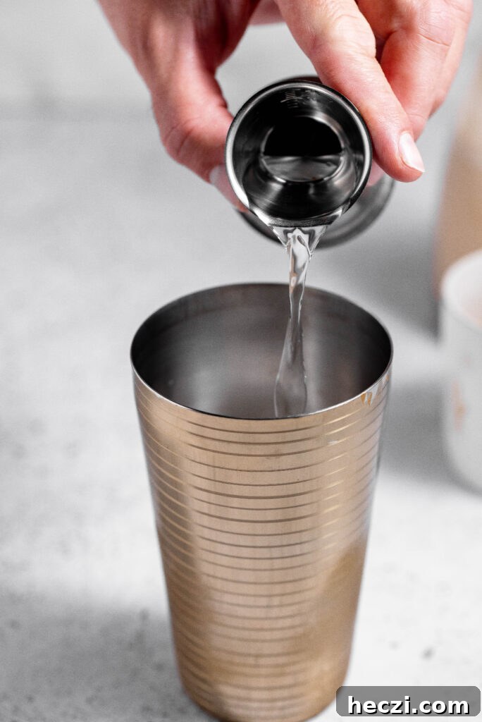 Vodka being added to cocktail shaker. 